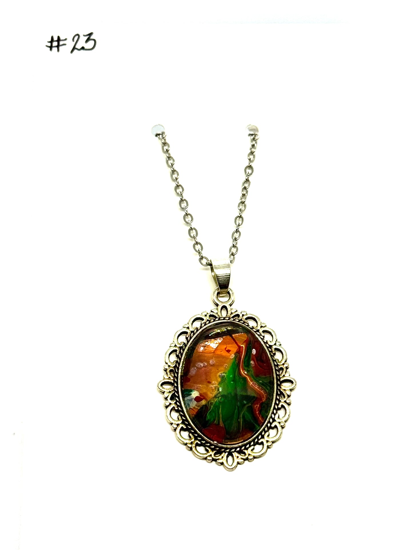 #23 “Don’t Look Too Long” Oval Pendant Necklace – Orange, Green & Red Paint Pour with Hidden Faces