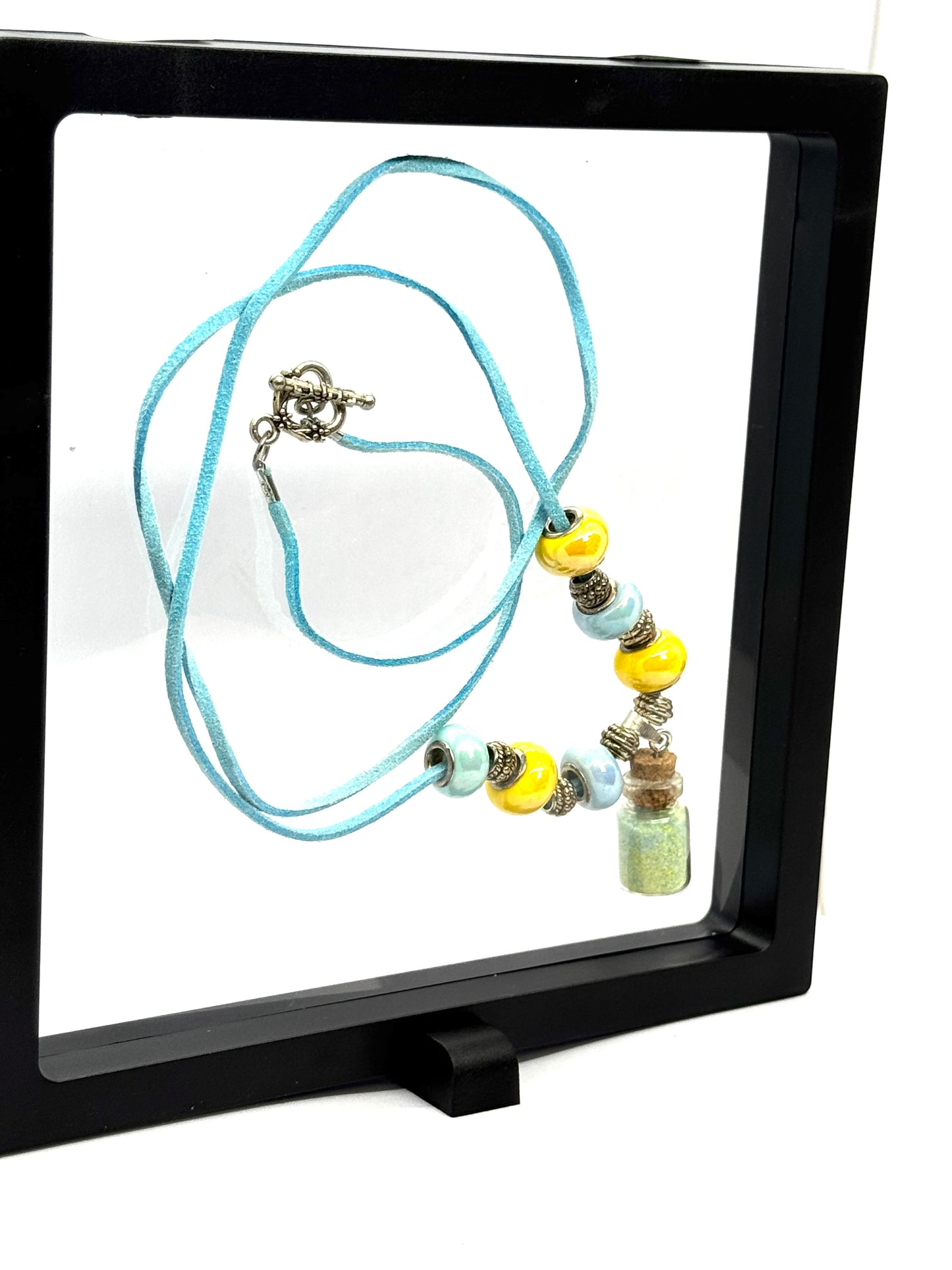 “Calm on the Surface, Chaos in a Bottle” Blue Cord Beaded Necklace | 32” | Toggle Clasp | Glitter Bottle Pendant