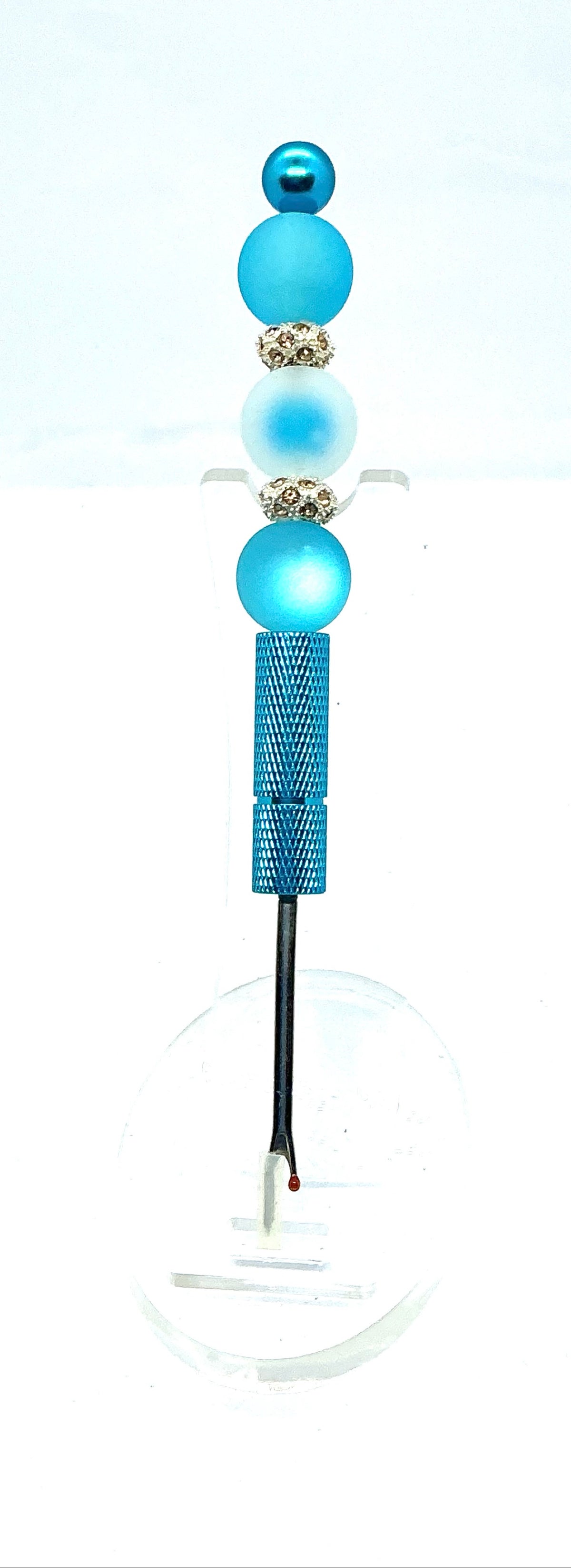 Beaded seam ripper with frosty blue beads and rhinestone spacers on a sky blue handle