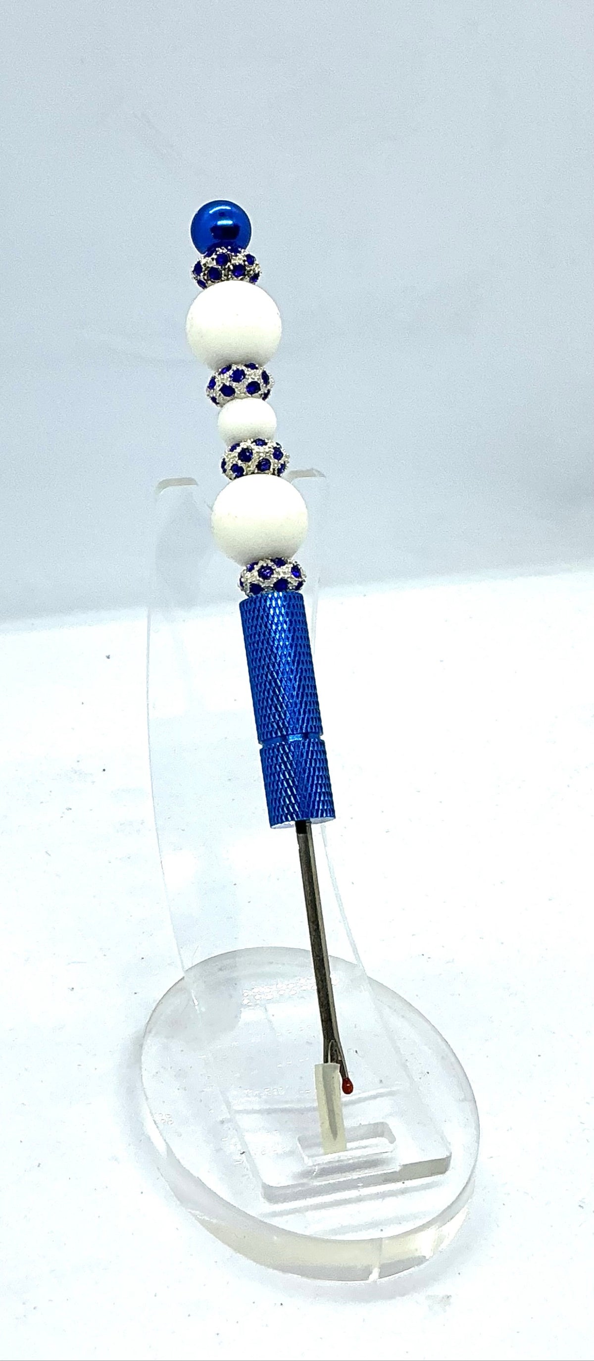 Beaded seam ripper with white beads and royal blue rhinestone spacers on a royal blue handle
