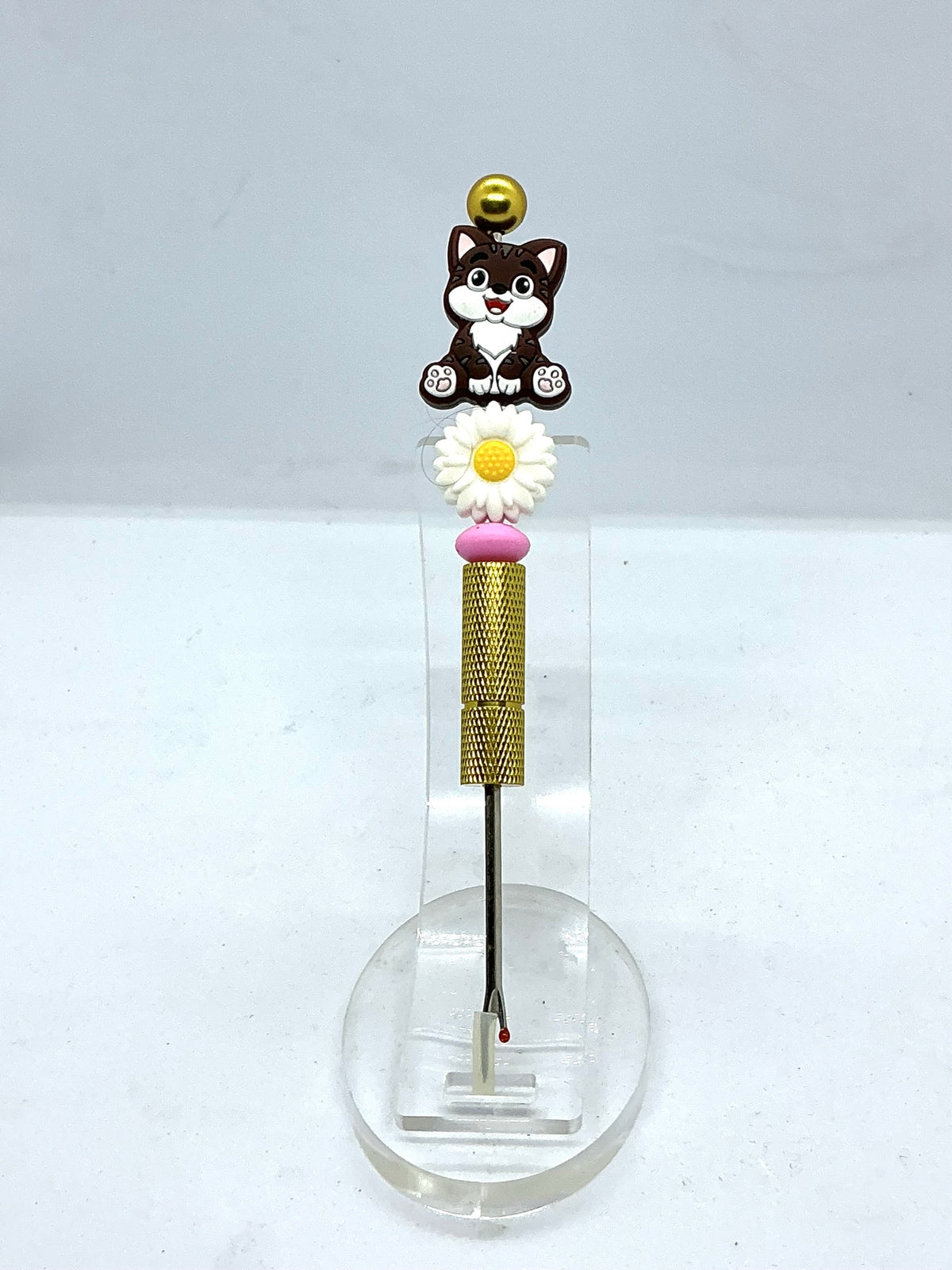 Beaded seam ripper with tabby cat and daisy beads on a gold-tone handle