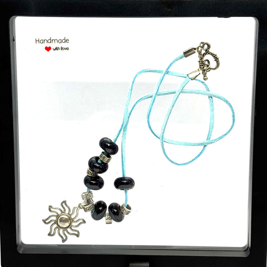 Sky Blue Cord Sun Charm Necklace | 23” Handmade Beaded Necklace | Black Glass Beads | Toggle Clasp Statement Piece