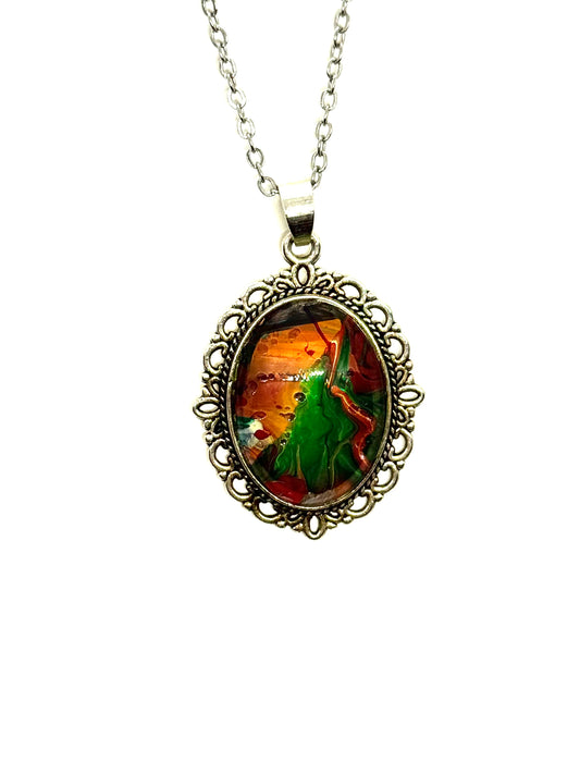 #23 “Don’t Look Too Long” Oval Pendant Necklace – Orange, Green & Red Paint Pour with Hidden Faces