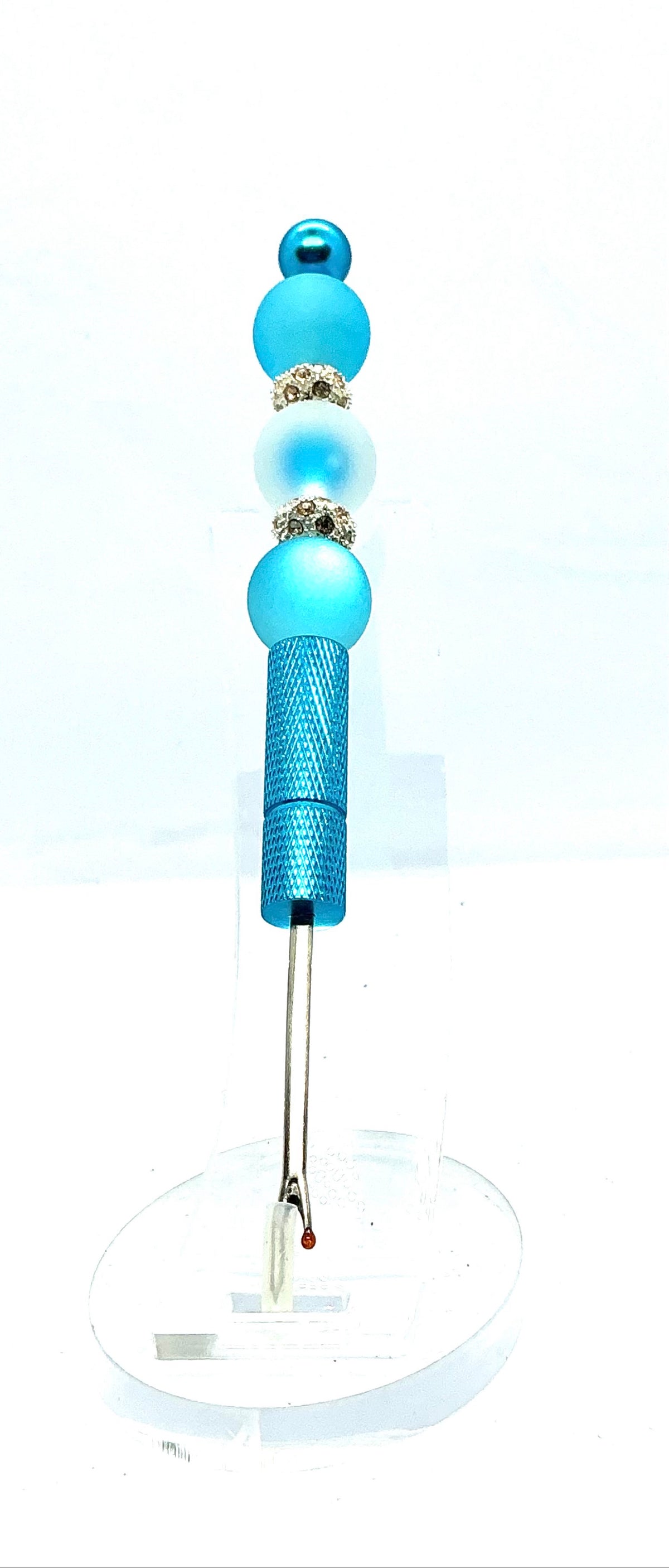 Beaded seam ripper with frosty blue beads and rhinestone spacers on a sky blue handle