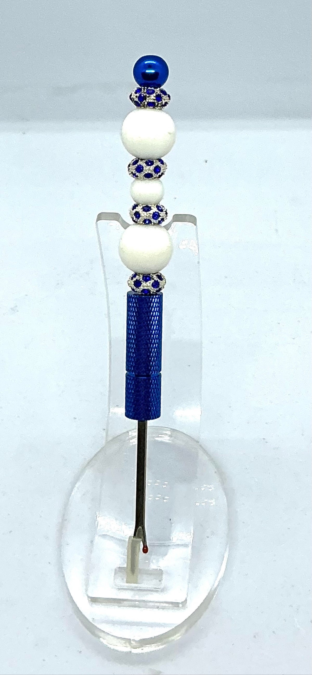 Beaded seam ripper with white beads and royal blue rhinestone spacers on a royal blue handle