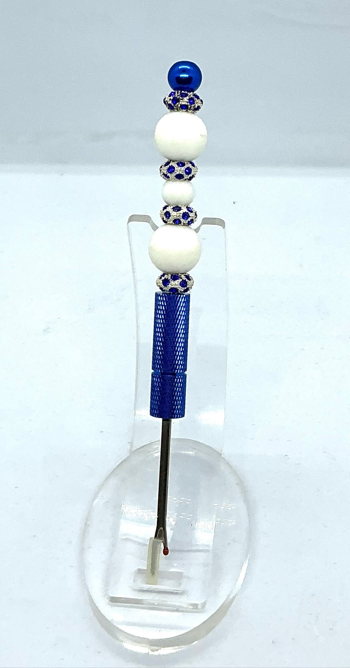 Beaded seam ripper with white beads and royal blue rhinestone spacers on a royal blue handle