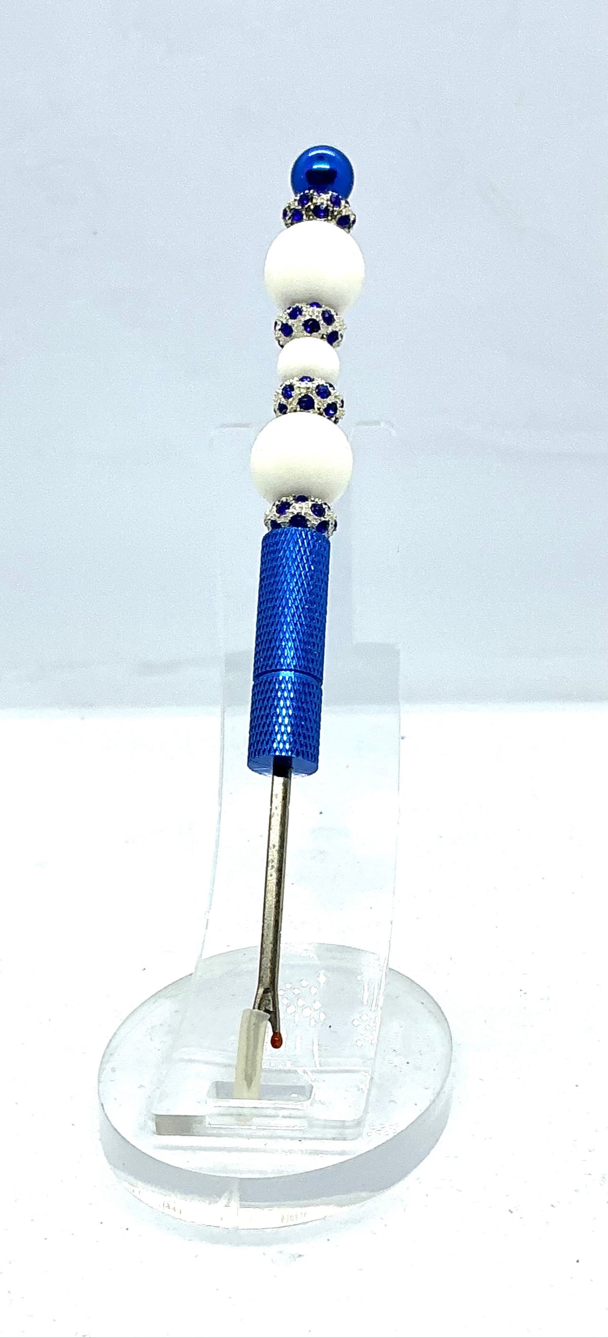 Beaded seam ripper with white beads and royal blue rhinestone spacers on a royal blue handle