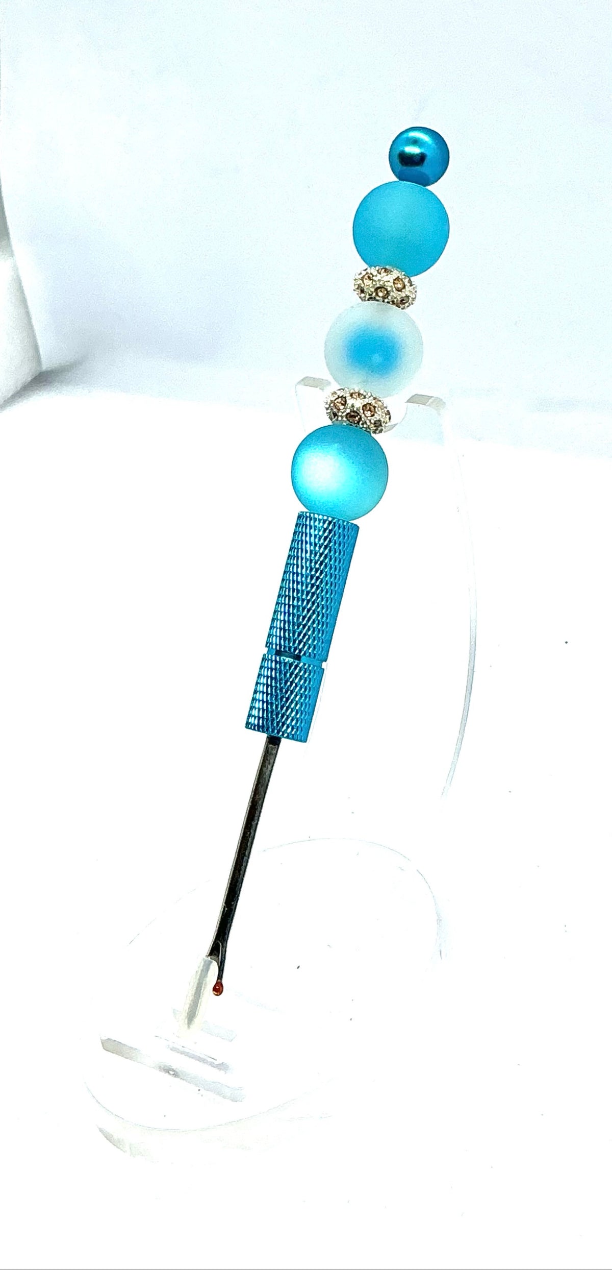Beaded seam ripper with frosty blue beads and rhinestone spacers on a sky blue handle