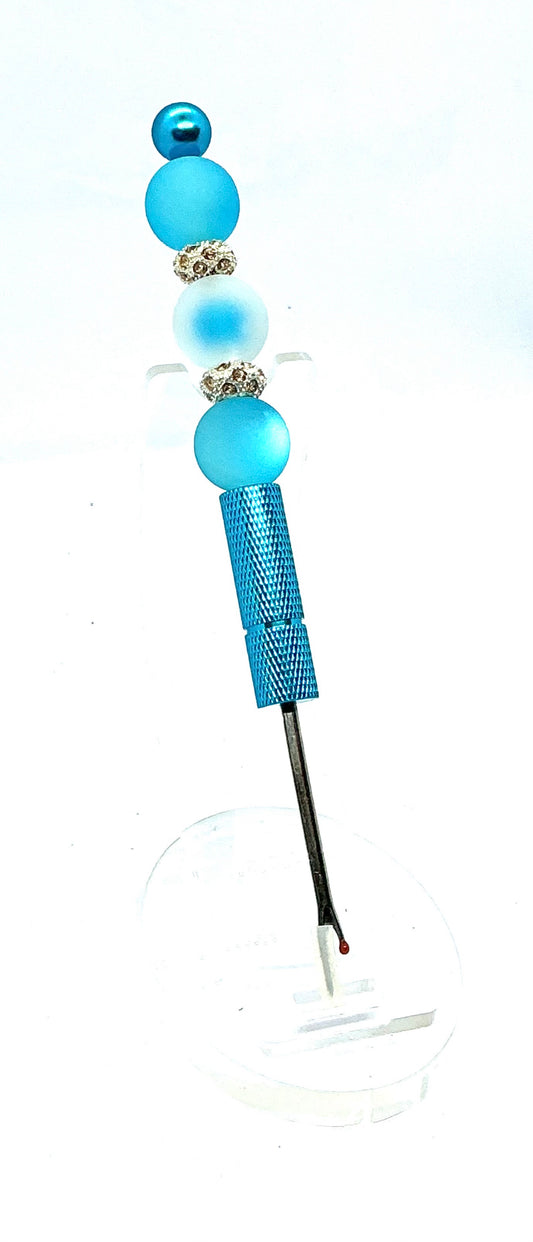 Beaded seam ripper with frosty blue beads and rhinestone spacers on a sky blue handle