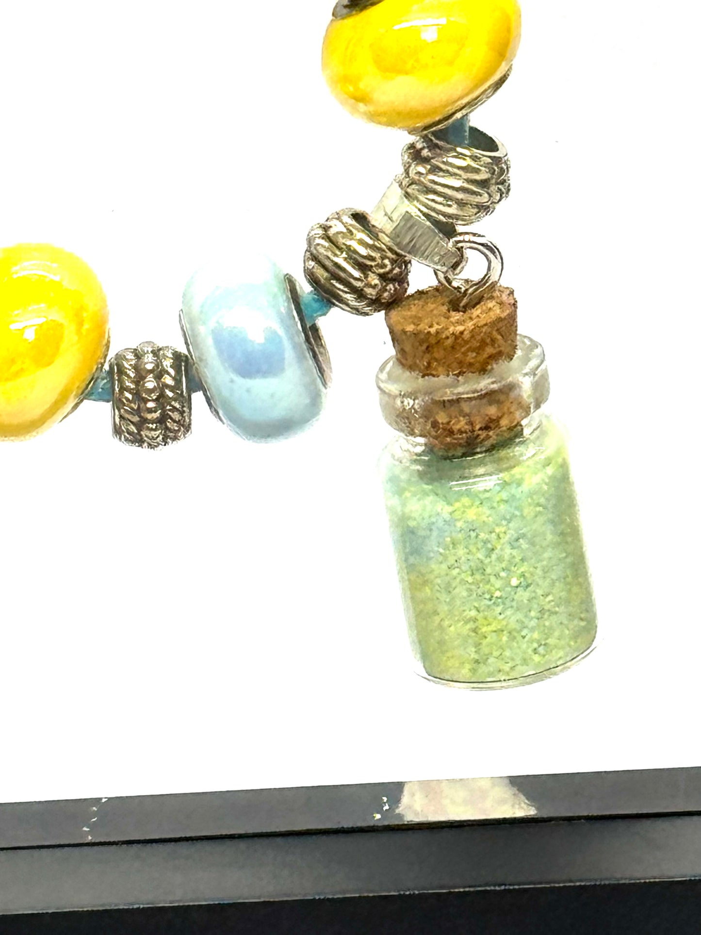 “Calm on the Surface, Chaos in a Bottle” Blue Cord Beaded Necklace | 32” | Toggle Clasp | Glitter Bottle Pendant