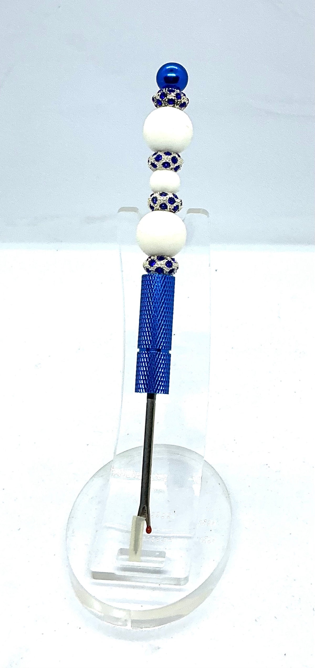 Beaded seam ripper with white beads and royal blue rhinestone spacers on a royal blue handle