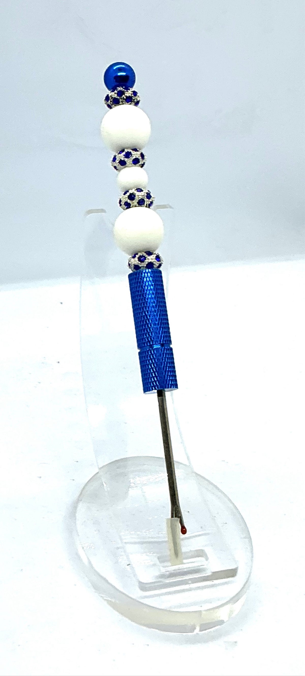 Beaded seam ripper with white beads and royal blue rhinestone spacers on a royal blue handle