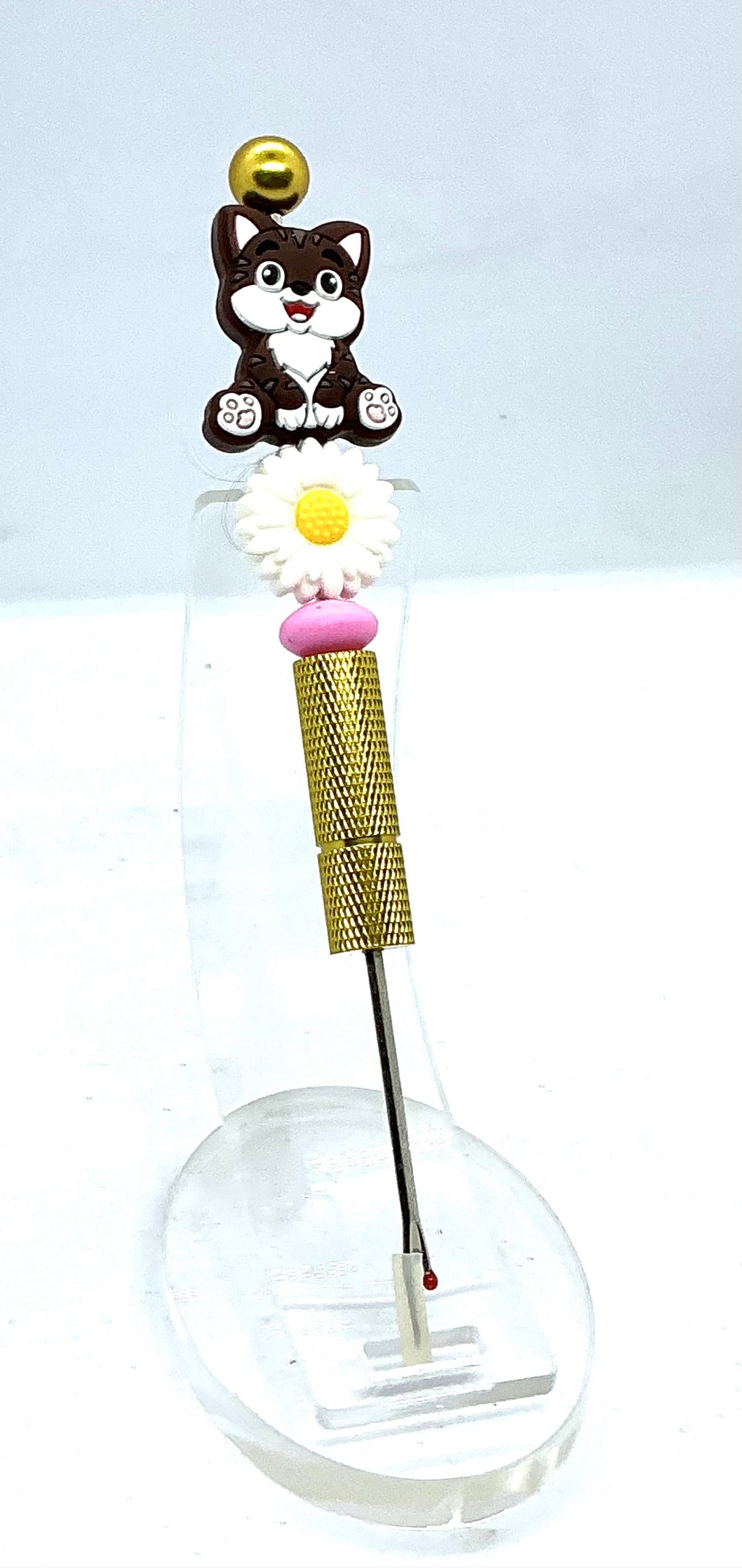 Beaded seam ripper with tabby cat and daisy beads on a gold-tone handle