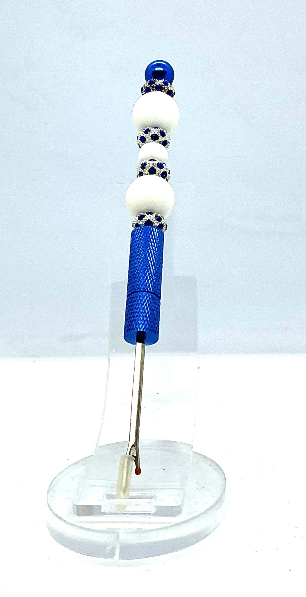 Beaded seam ripper with white beads and royal blue rhinestone spacers on a royal blue handle