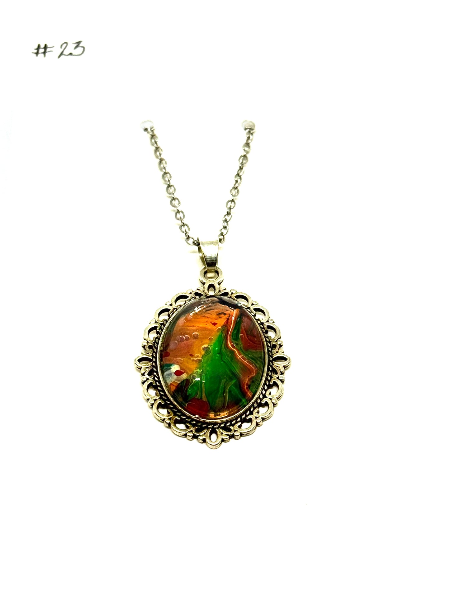 #23 “Don’t Look Too Long” Oval Pendant Necklace – Orange, Green & Red Paint Pour with Hidden Faces