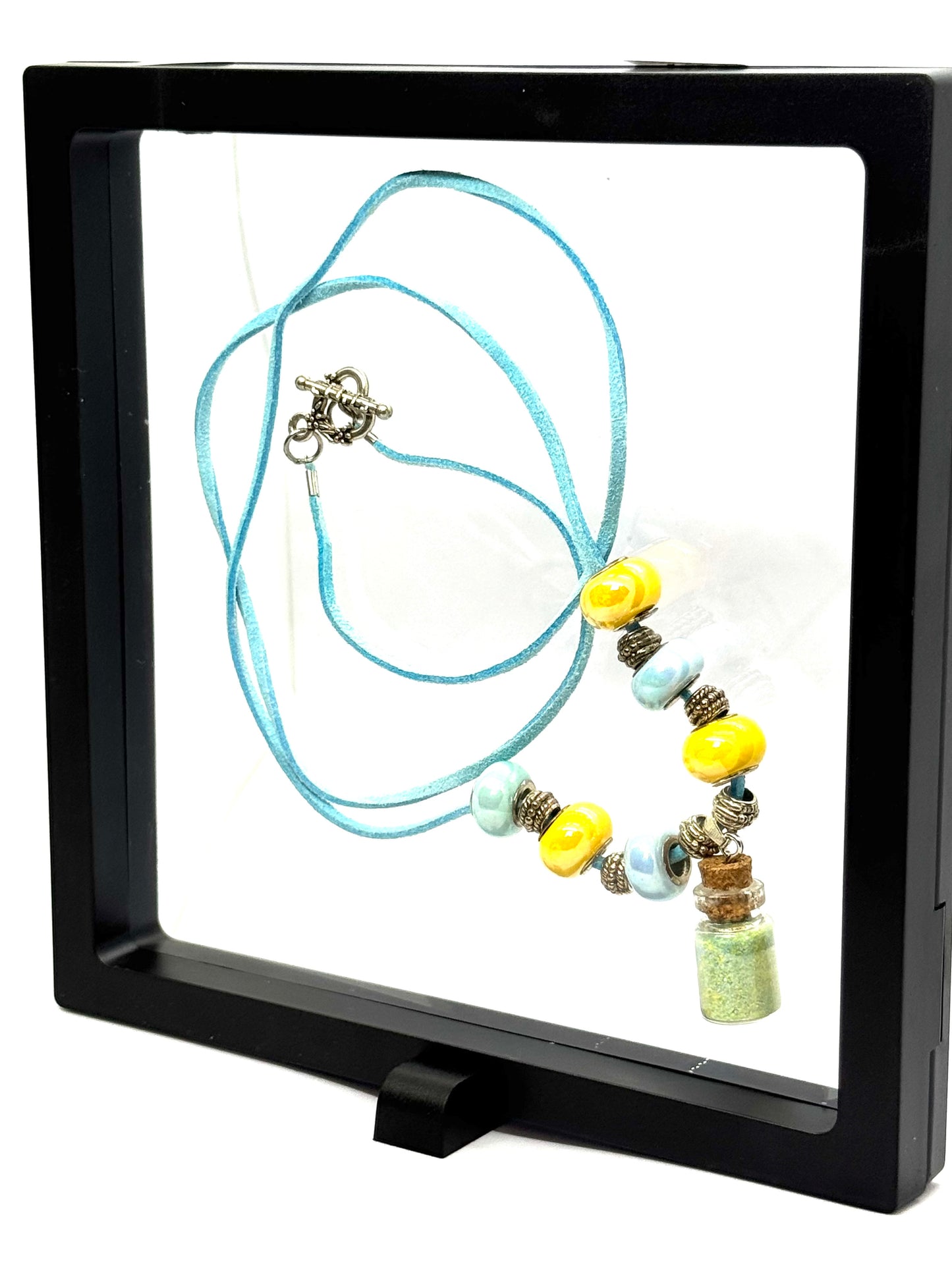 “Calm on the Surface, Chaos in a Bottle” Blue Cord Beaded Necklace | 32” | Toggle Clasp | Glitter Bottle Pendant