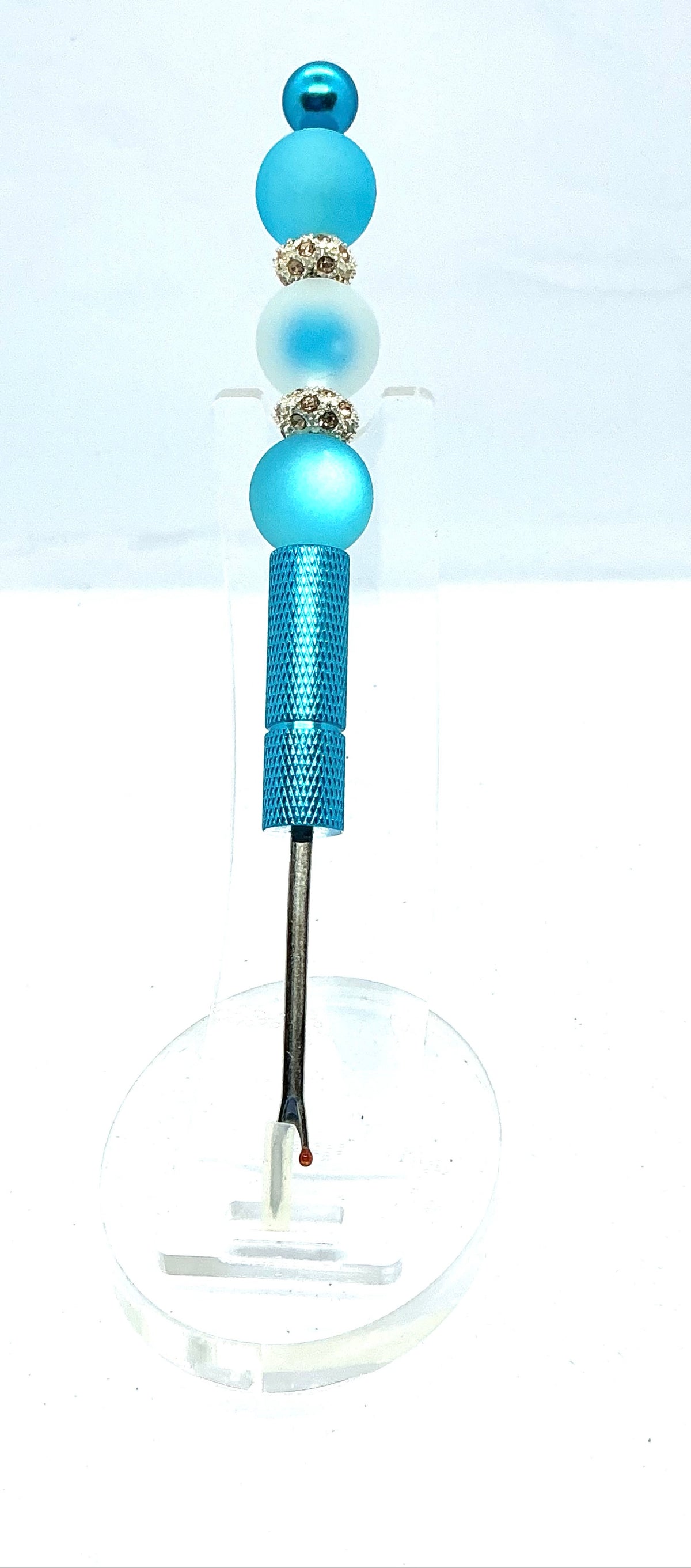 Beaded seam ripper with frosty blue beads and rhinestone spacers on a sky blue handle