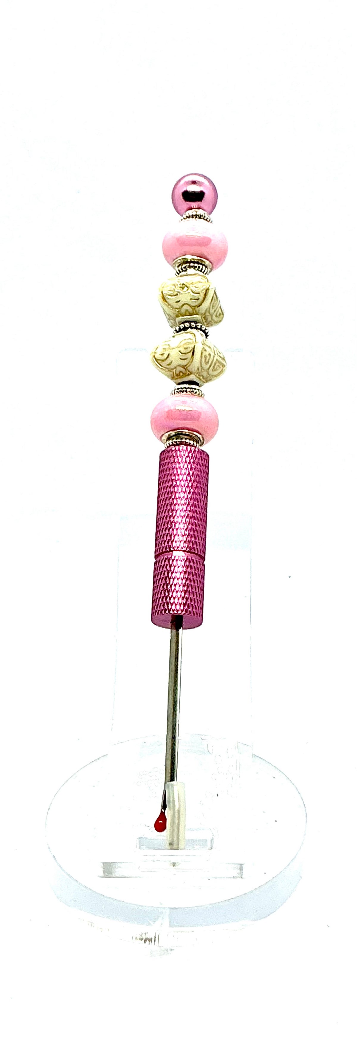 Beaded seam ripper with pink pearl and carved ivory-look beads on a pink handle