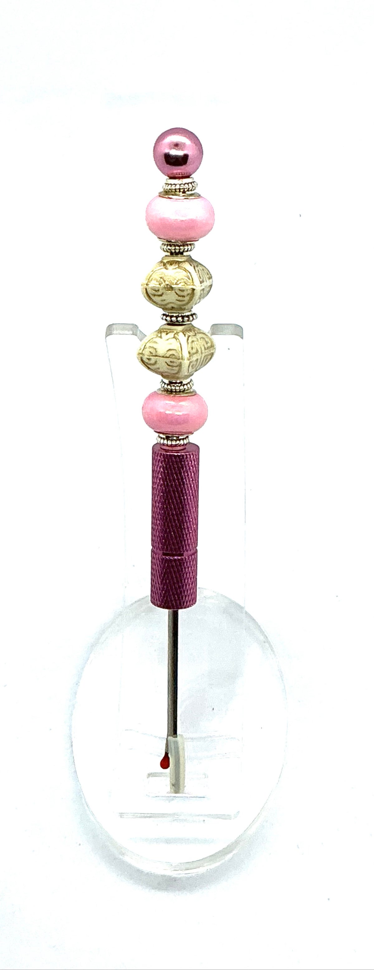 Beaded seam ripper with pink pearl and carved ivory-look beads on a pink handle