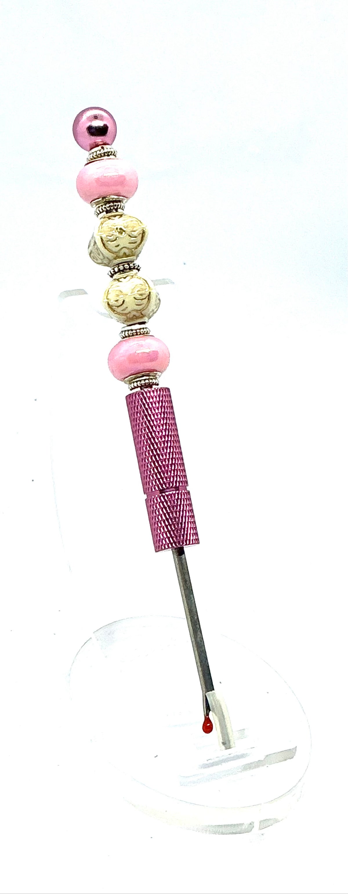Beaded seam ripper with pink pearl and carved ivory-look beads on a pink handle