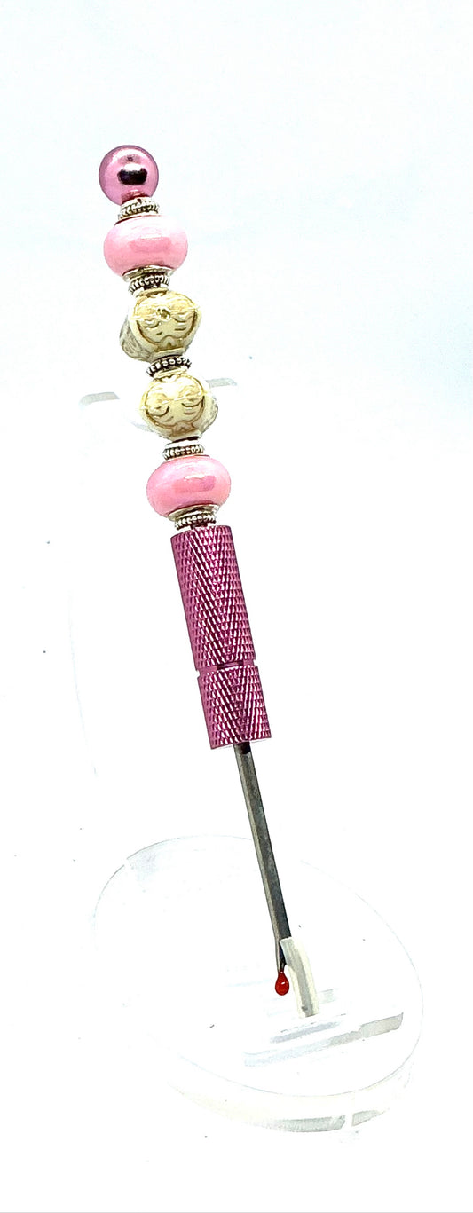 Beaded seam ripper with pink pearl and carved ivory-look beads on a pink handle