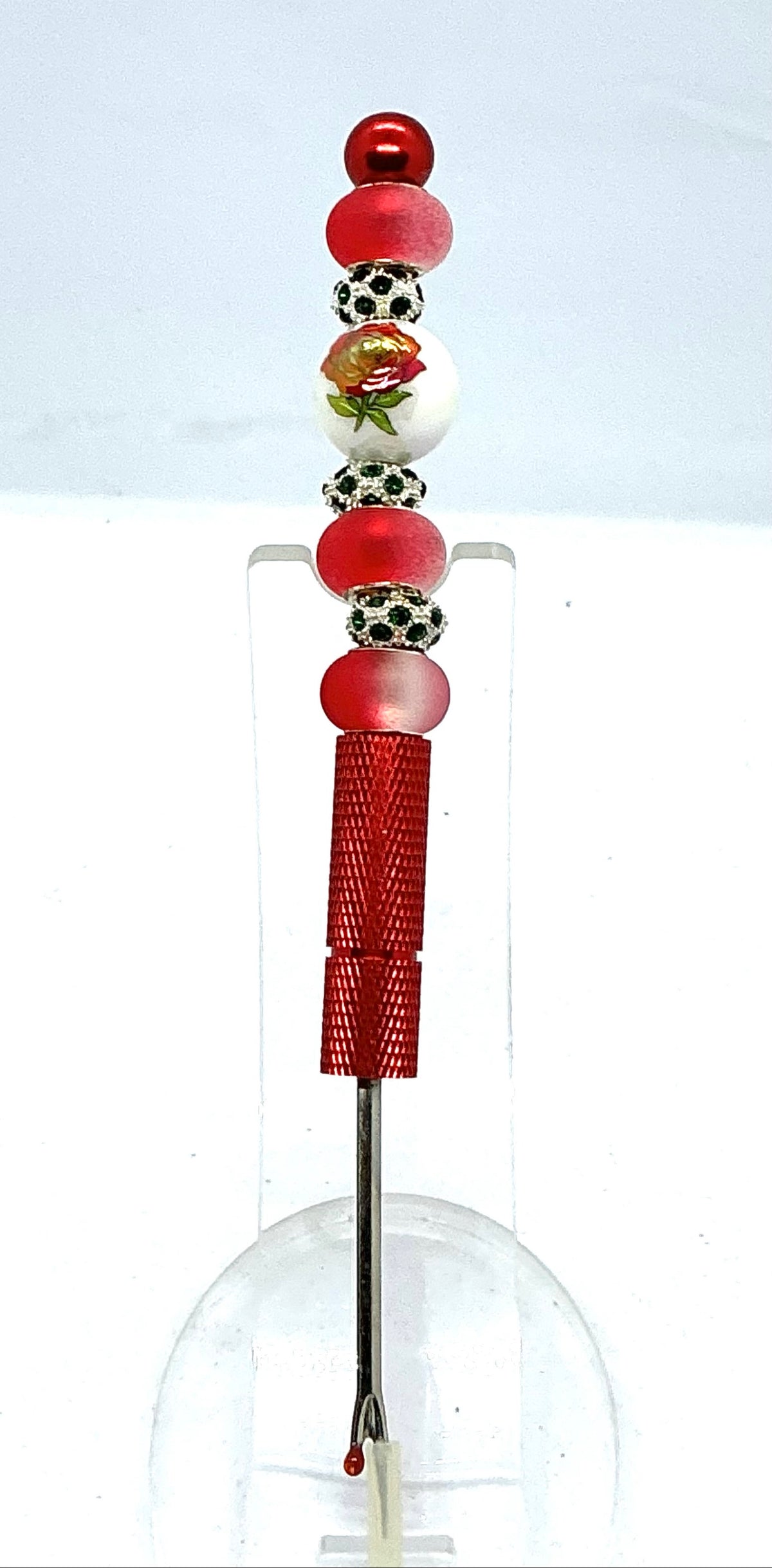 Beaded seam ripper with painted red rose bead and frosted red beads on a red handle