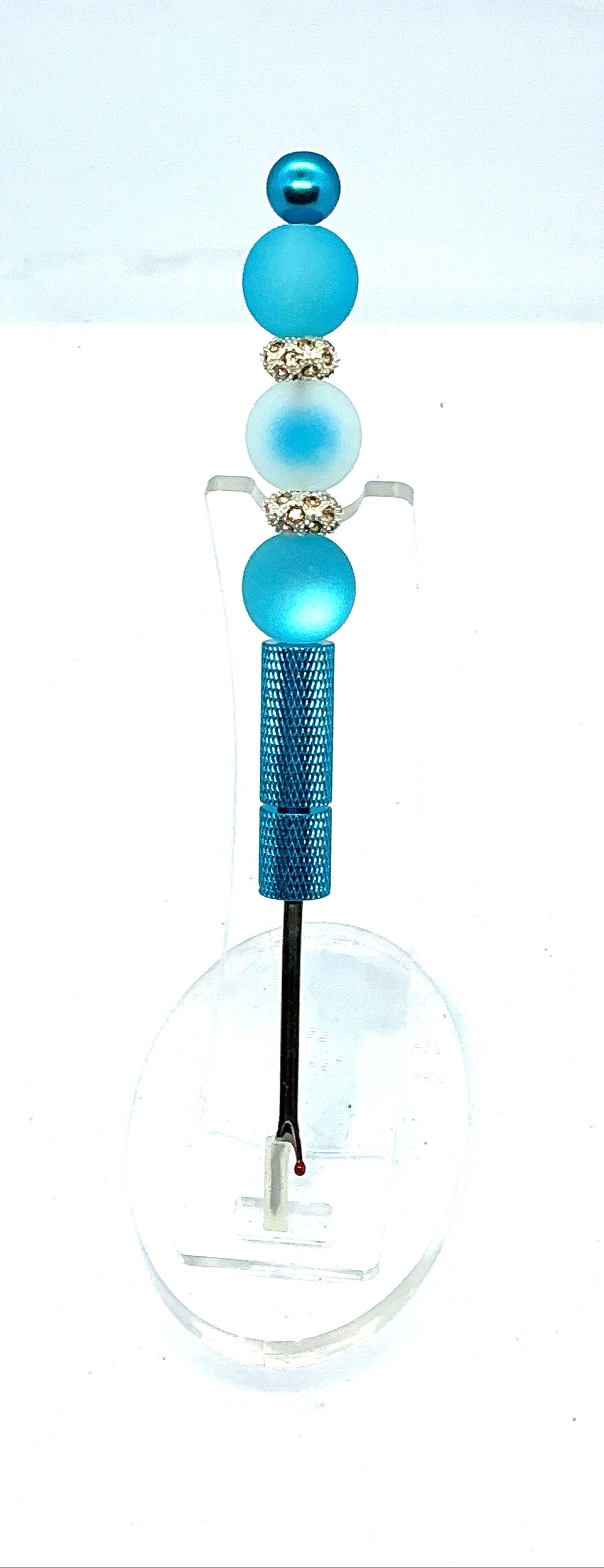 Beaded seam ripper with frosty blue beads and rhinestone spacers on a sky blue handle