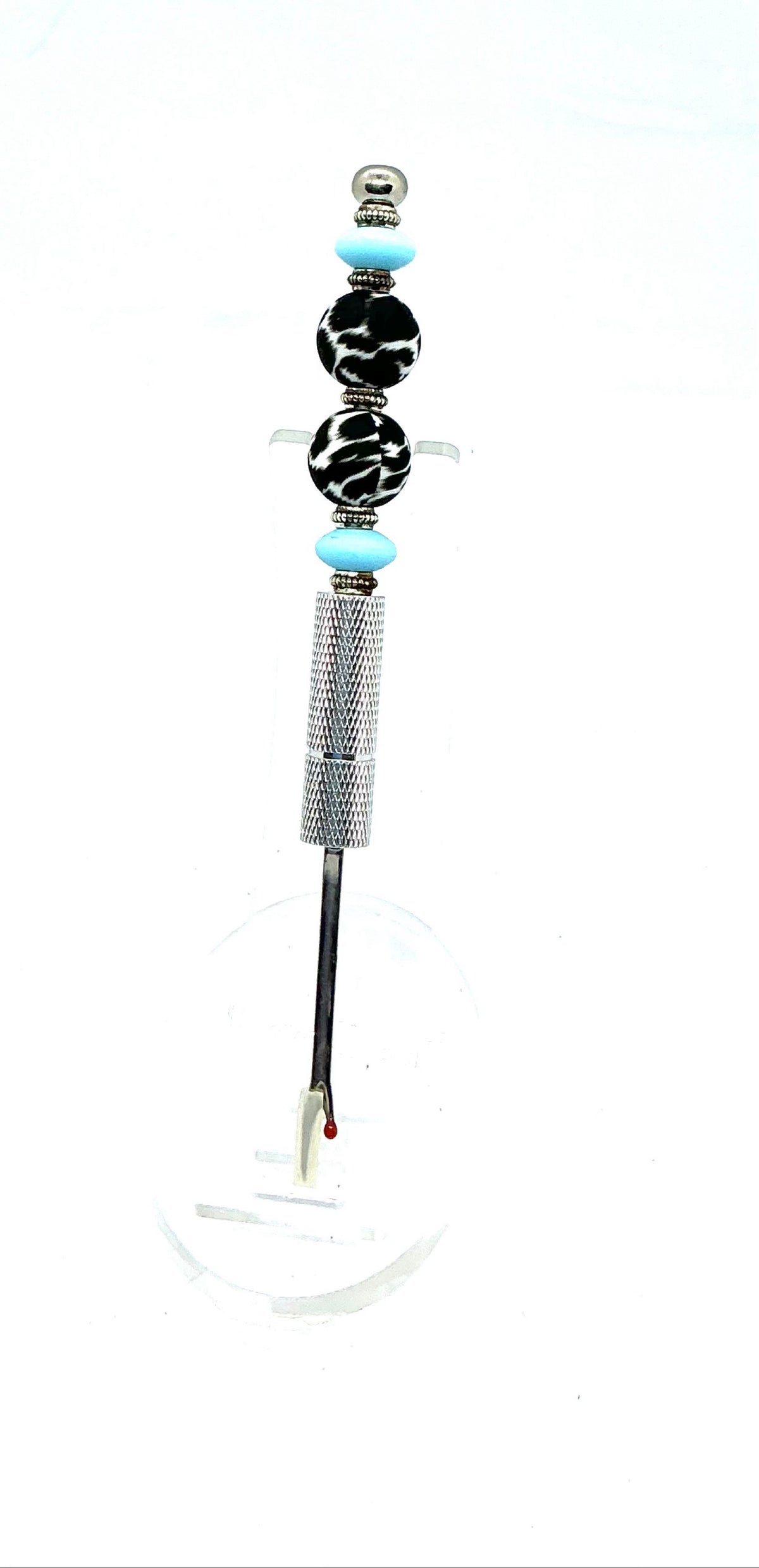 Beaded seam ripper with black-and-white zebra print beads and sky blue accents on a silver handle